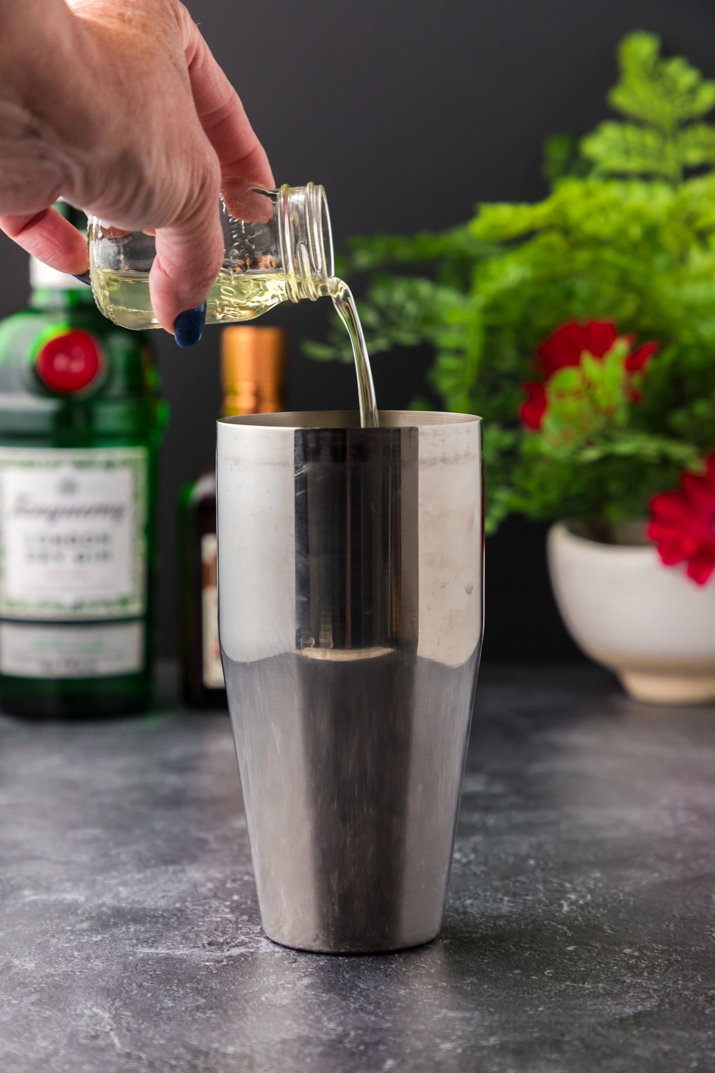 pouring egg whites into cocktail shaker