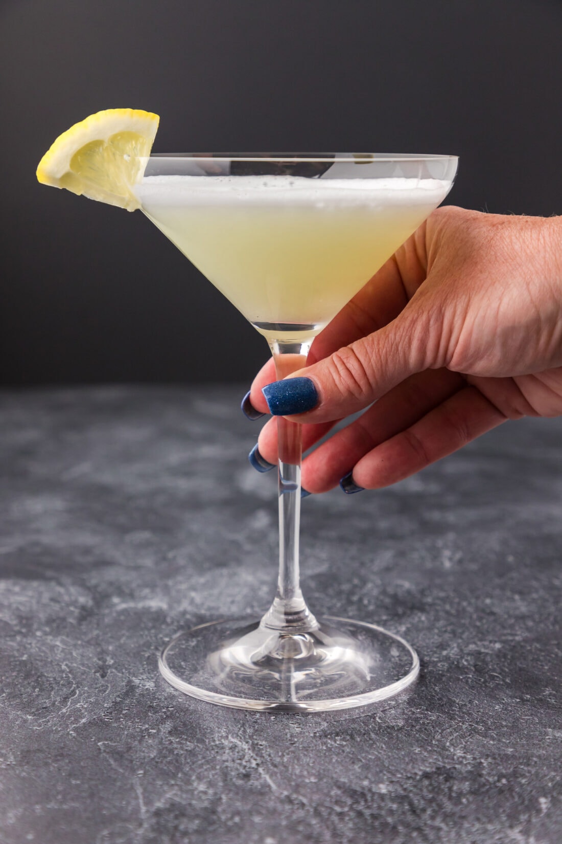 Hand holding a White Lady Cocktail