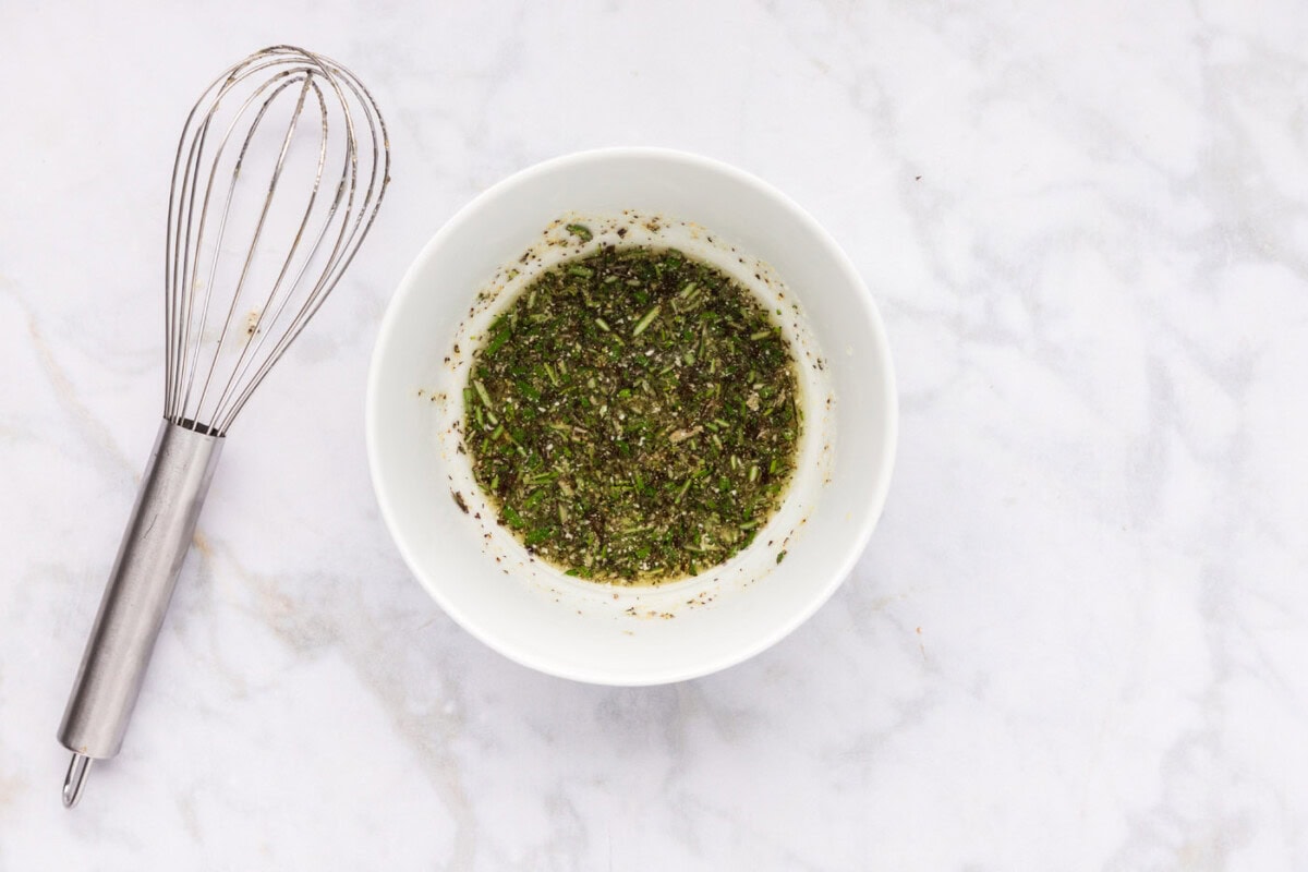 olive oil, rosemary, and seasoning mixture in a bowl