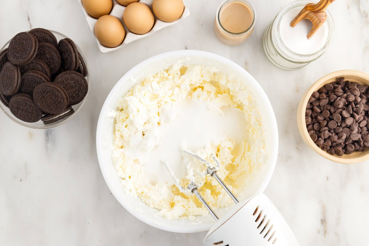blending cream cheese with sugar with a mixer