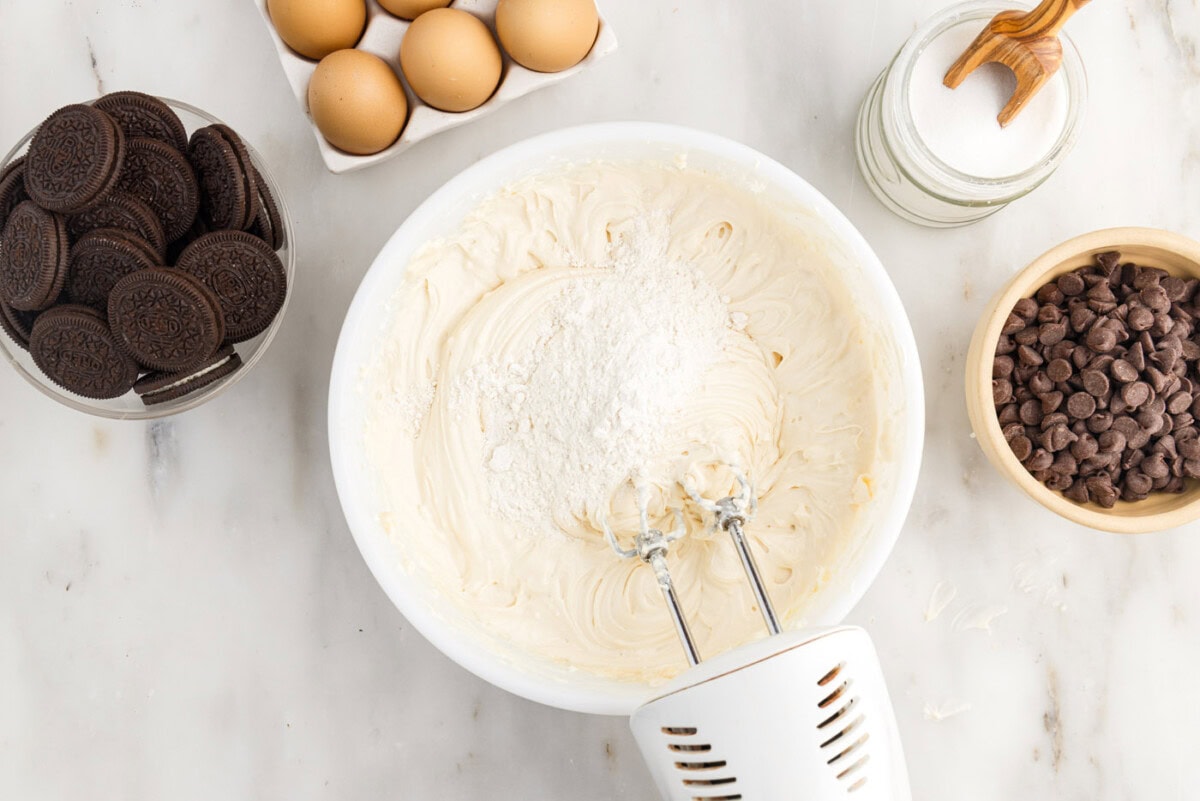 adding flour to cheesecake mixture