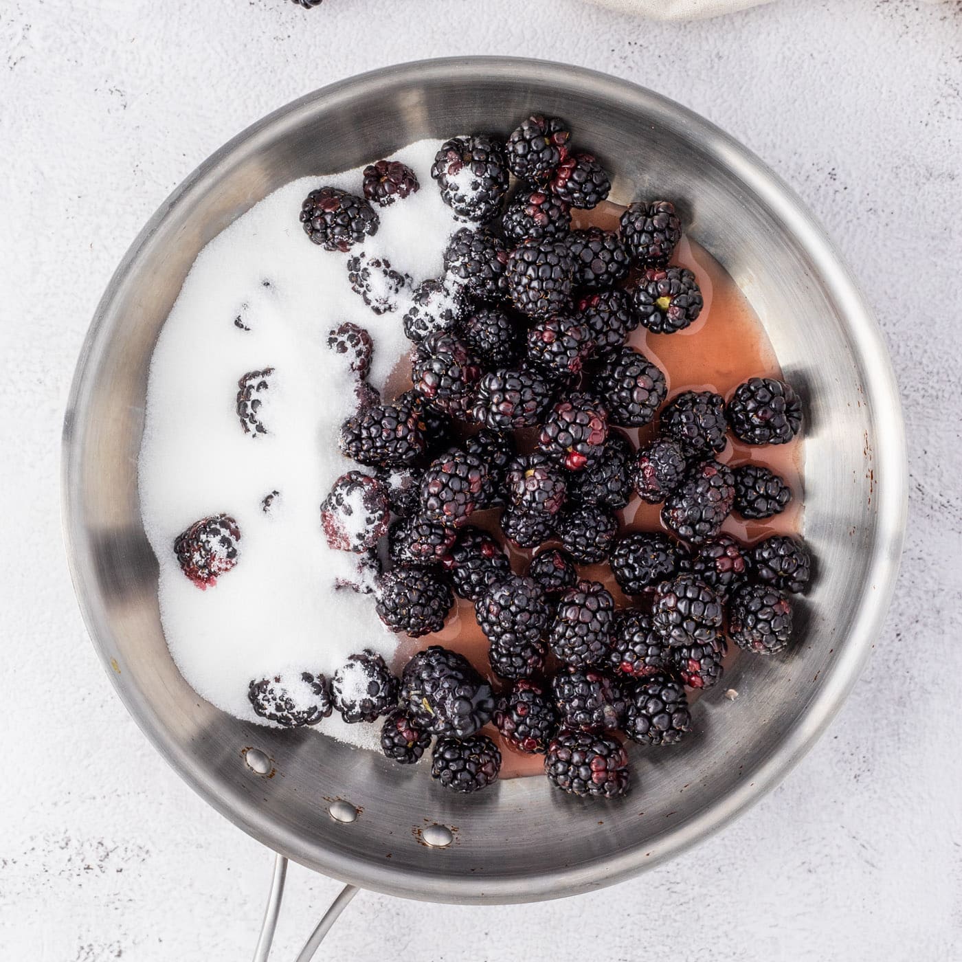 blackberries, sugar, and fruit nectar in a saucepan