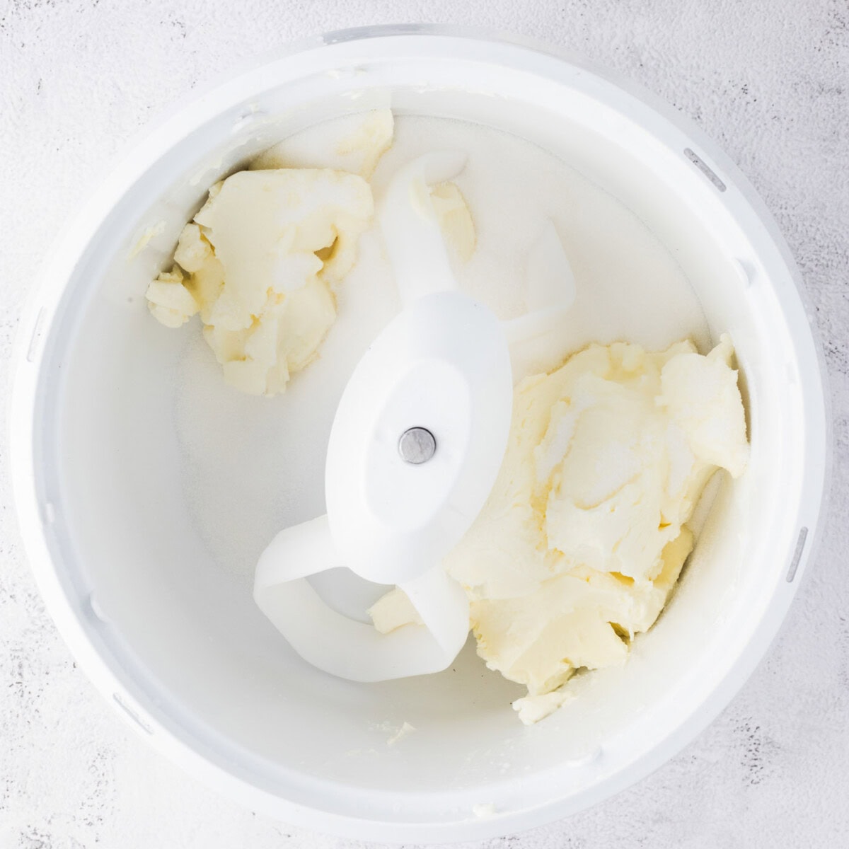 Cream cheese and sugar combined in a bowl
