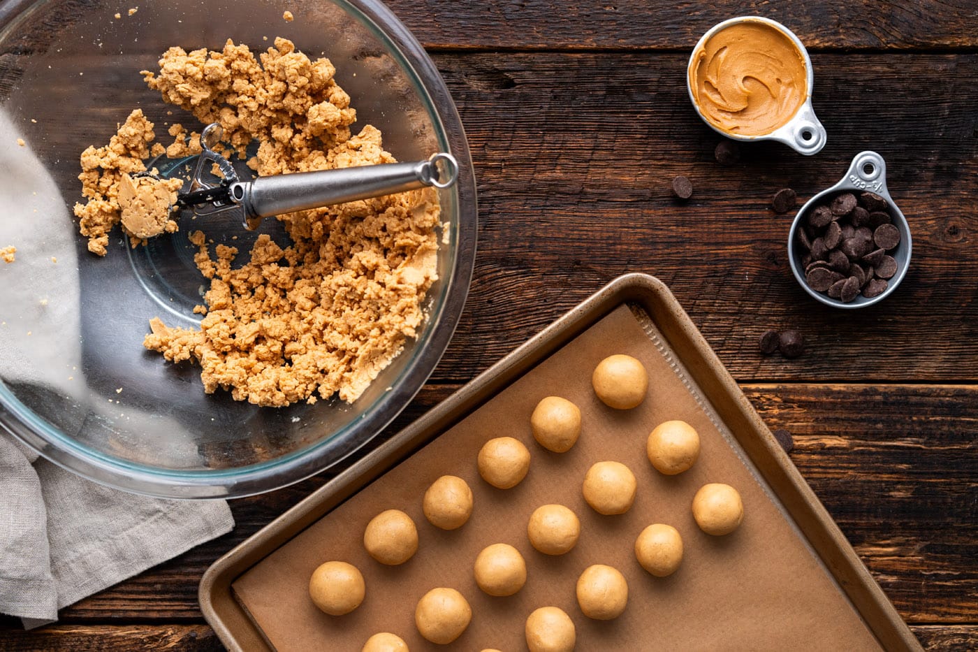 scooping peanut butter mixture into balls