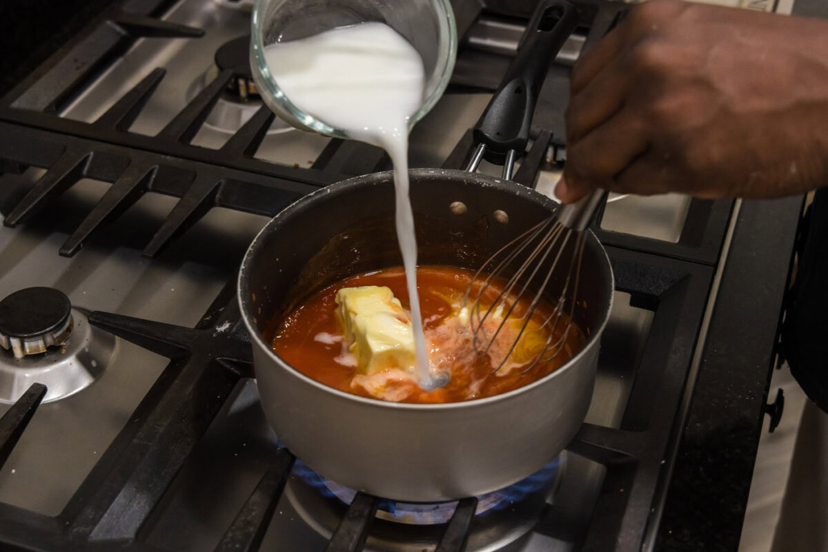 whisking a cornstarch slurry into buffalo sauce