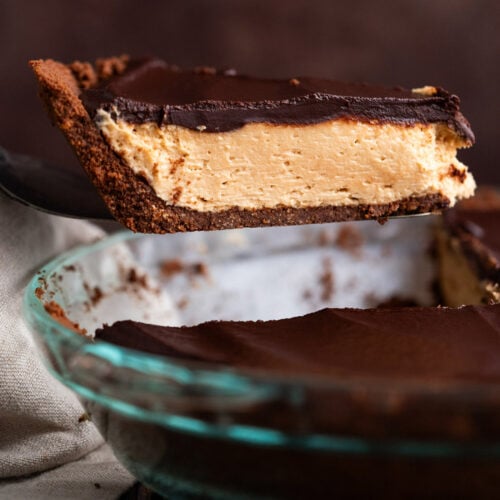 Slice of chocolate peanut butter pie being lifted out of the pie dish