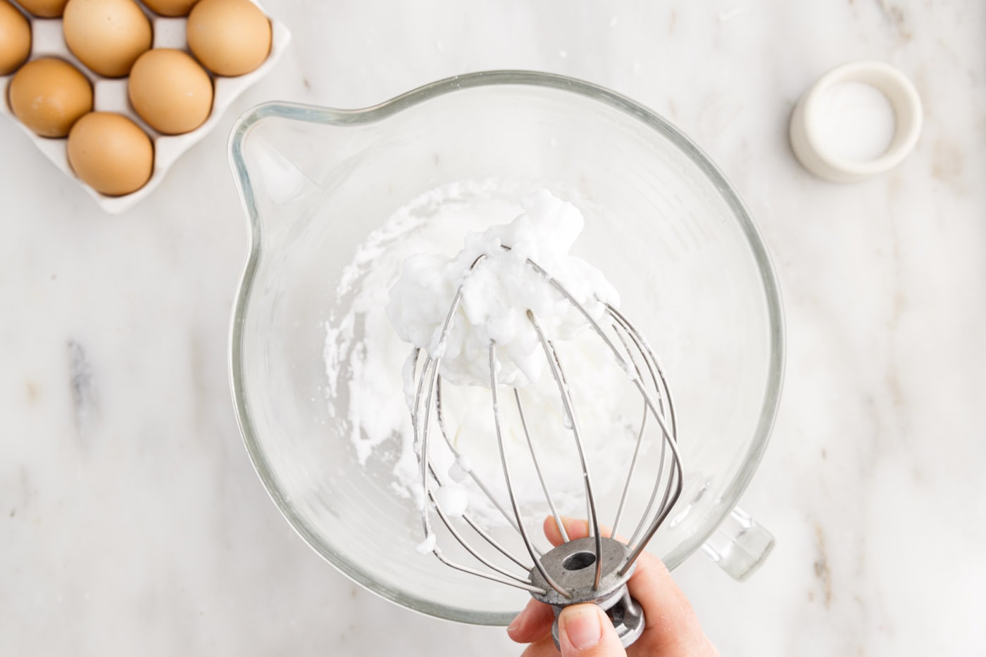 whipped egg whites with stiff peaks in a stand mixer bowl