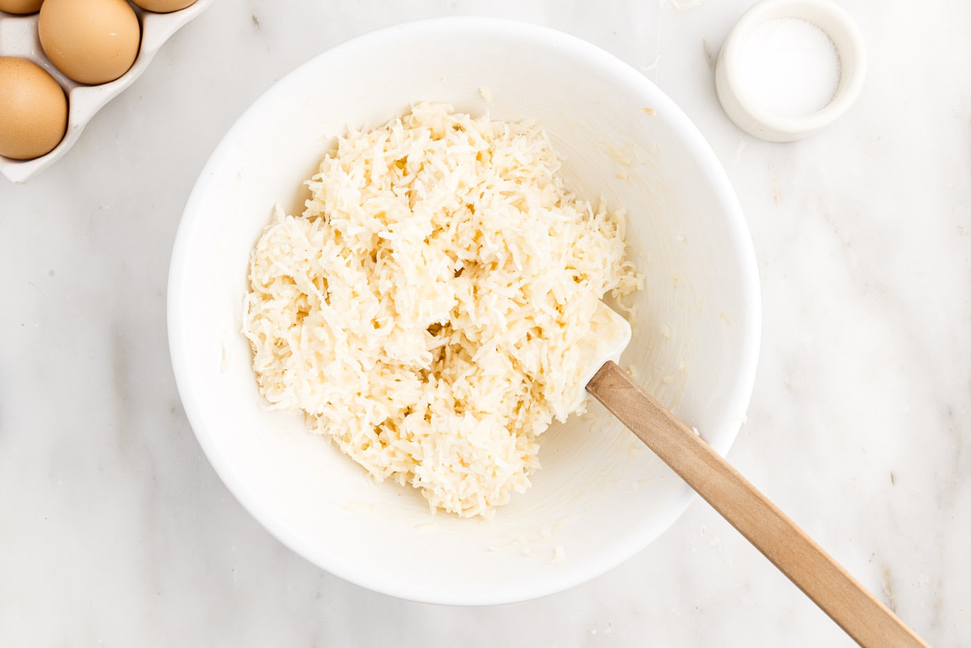 shredded coconut and sweetened condensed milk mixture in a bowl