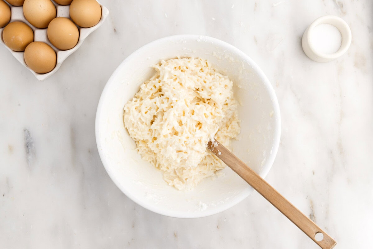 coconut macaroon ingredients in a bowl with rubber spatula