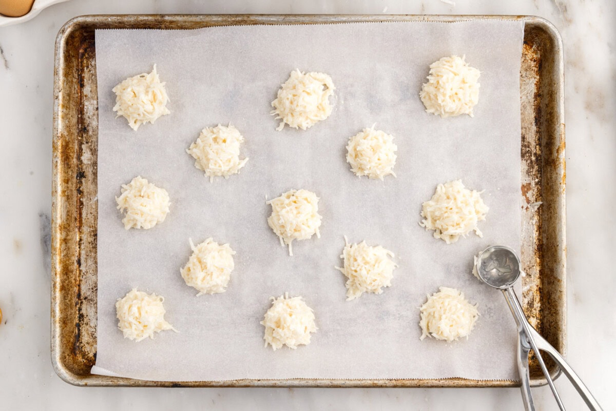 mounds of coconut macaroons on a baking sheet