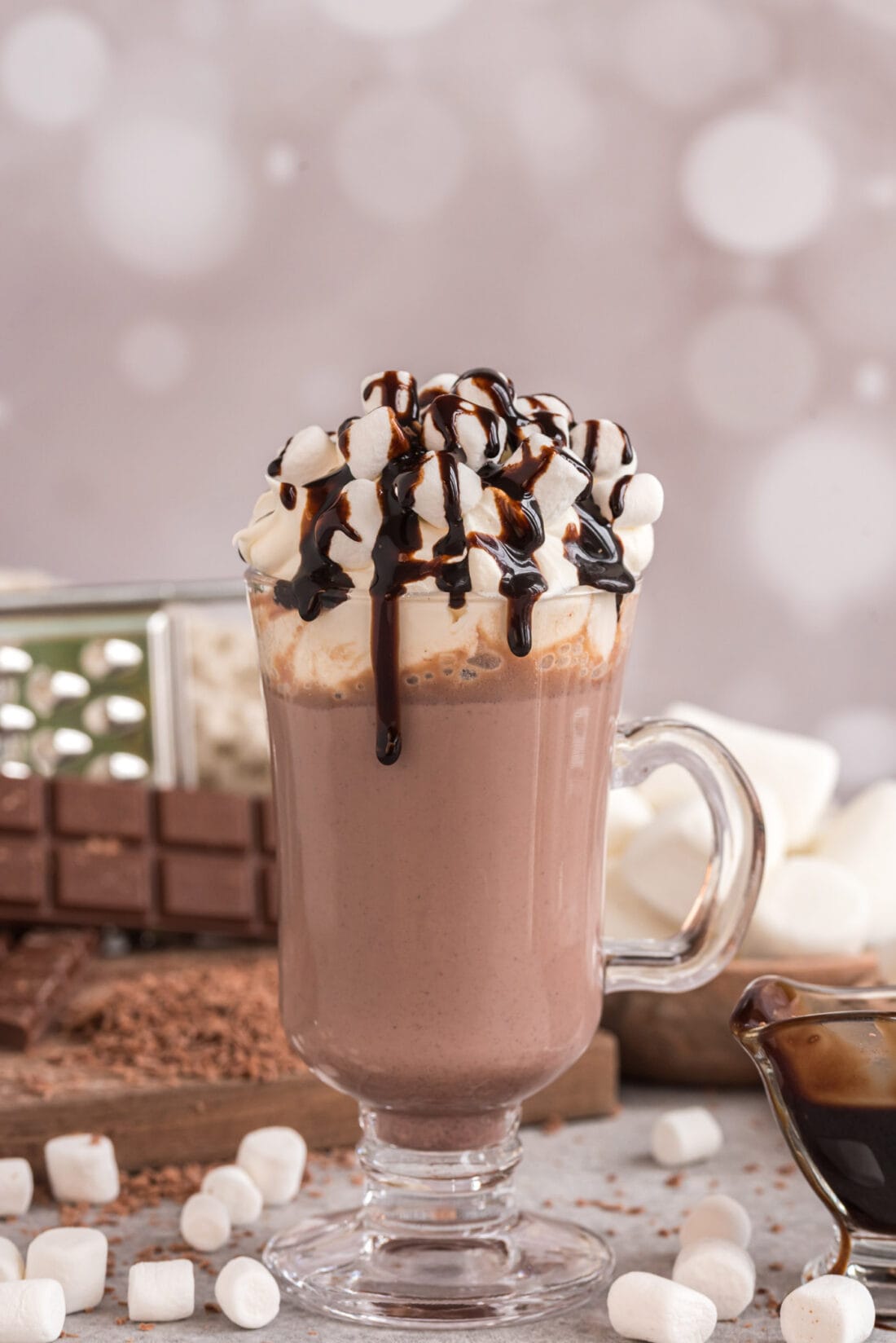 Mug of Crockpot Hot Chocolate topped with marshmallows and chocolate sauce