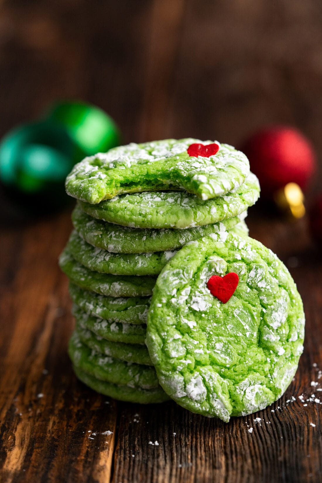 Stack of Grinch Cookies with a bite taken out of the top cookie