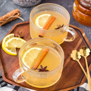 Close up photo of two Hot Toddy drinks on a wooden tray