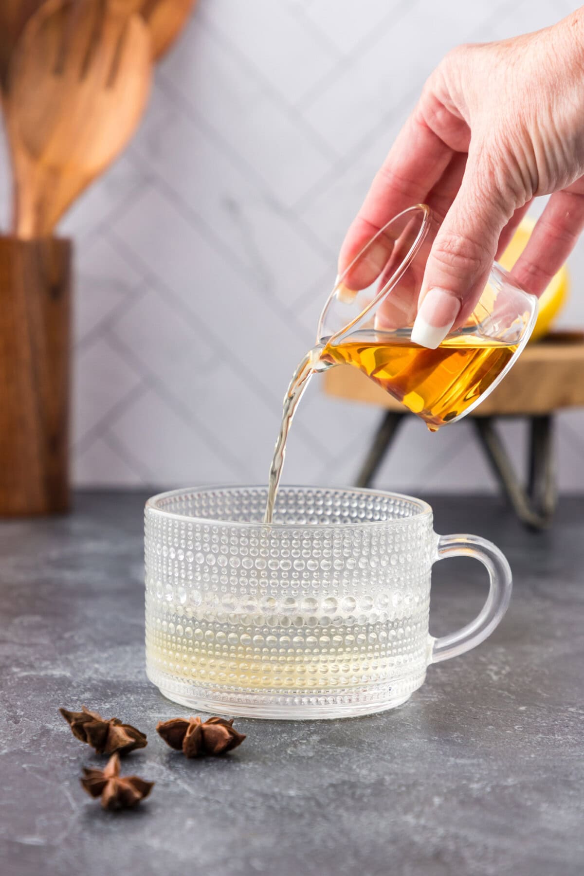 pouring bourbon into mug with water