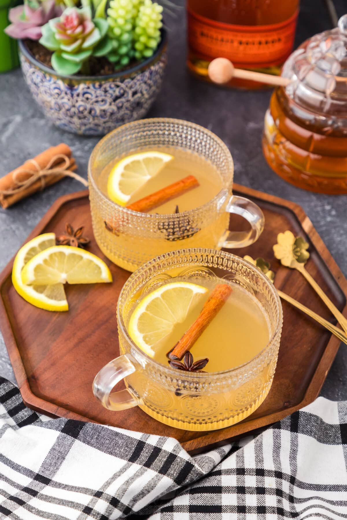 Two Hot Toddy drinks on a wooden serving tray
