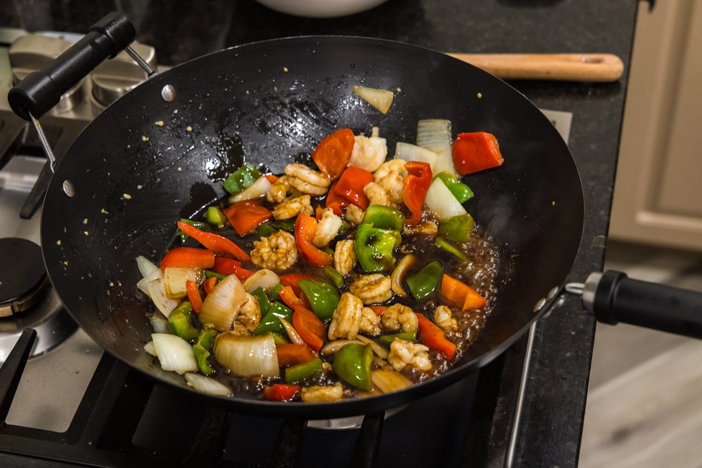 stir frying shrimp with vegetables