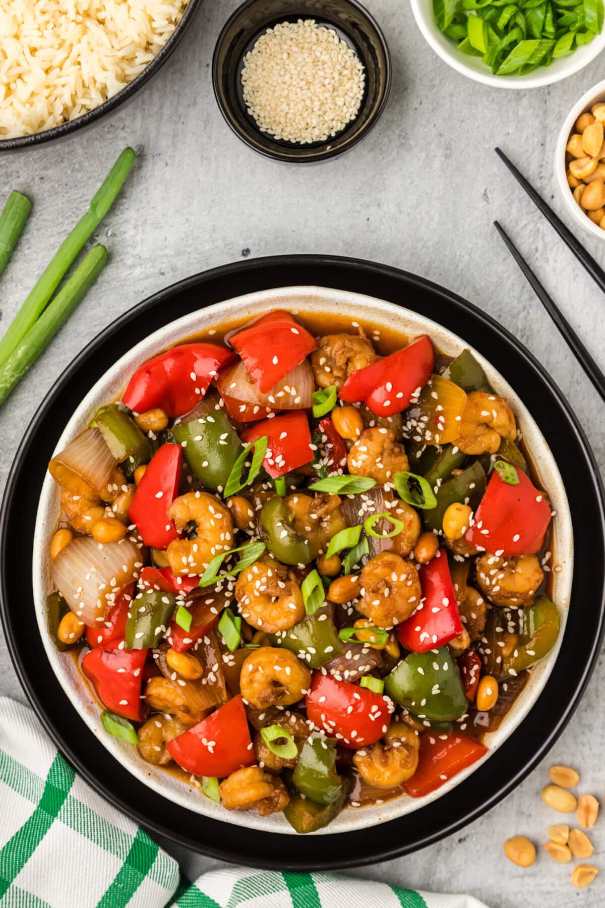 Plate of Kung Pao Shrimp with rice and peanuts on the side