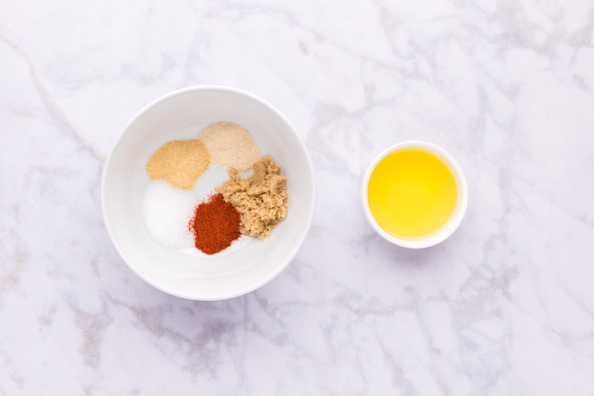 seasonings in a bowl next to olive oil