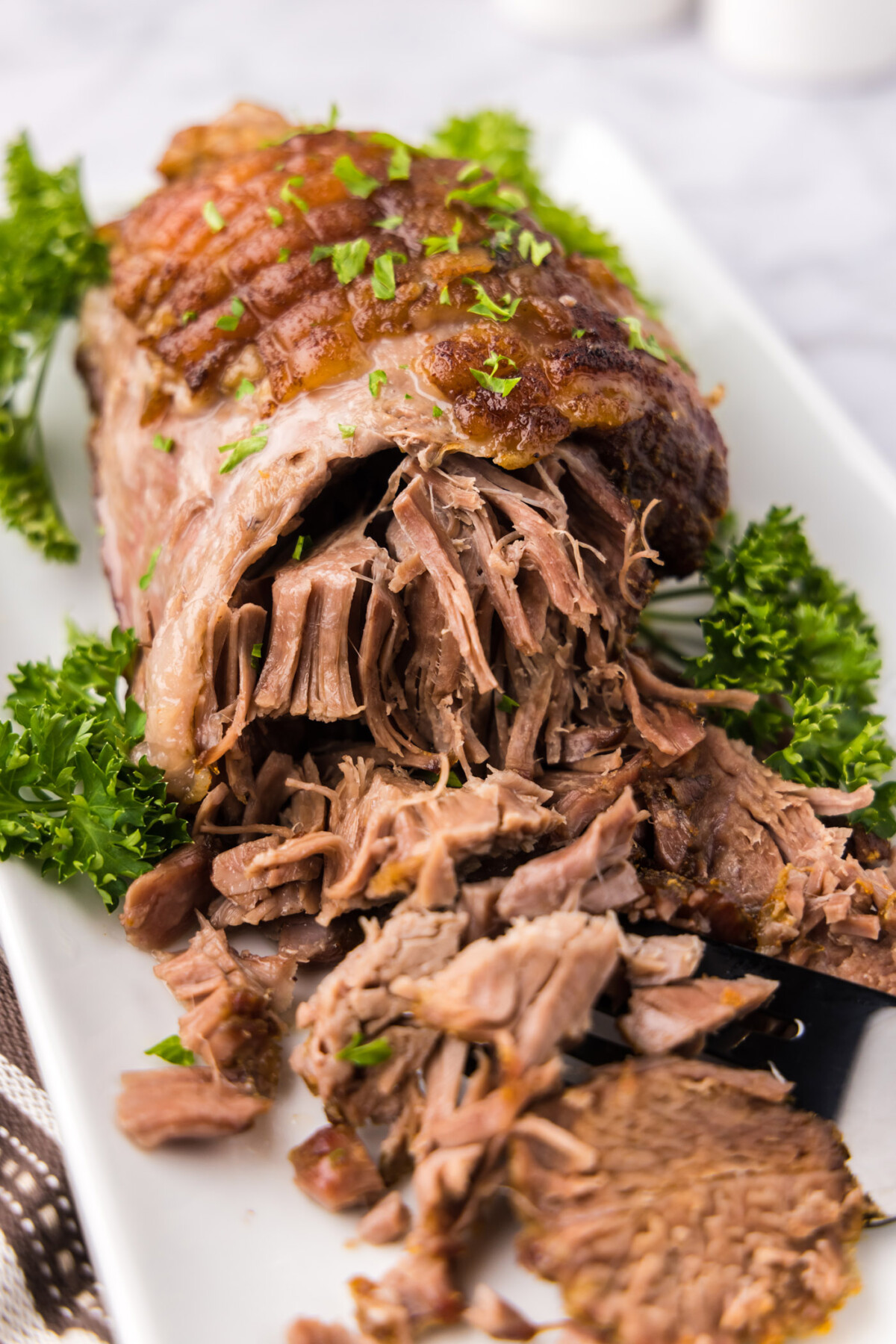 Close up photo of a Leg of Lamb on a platter