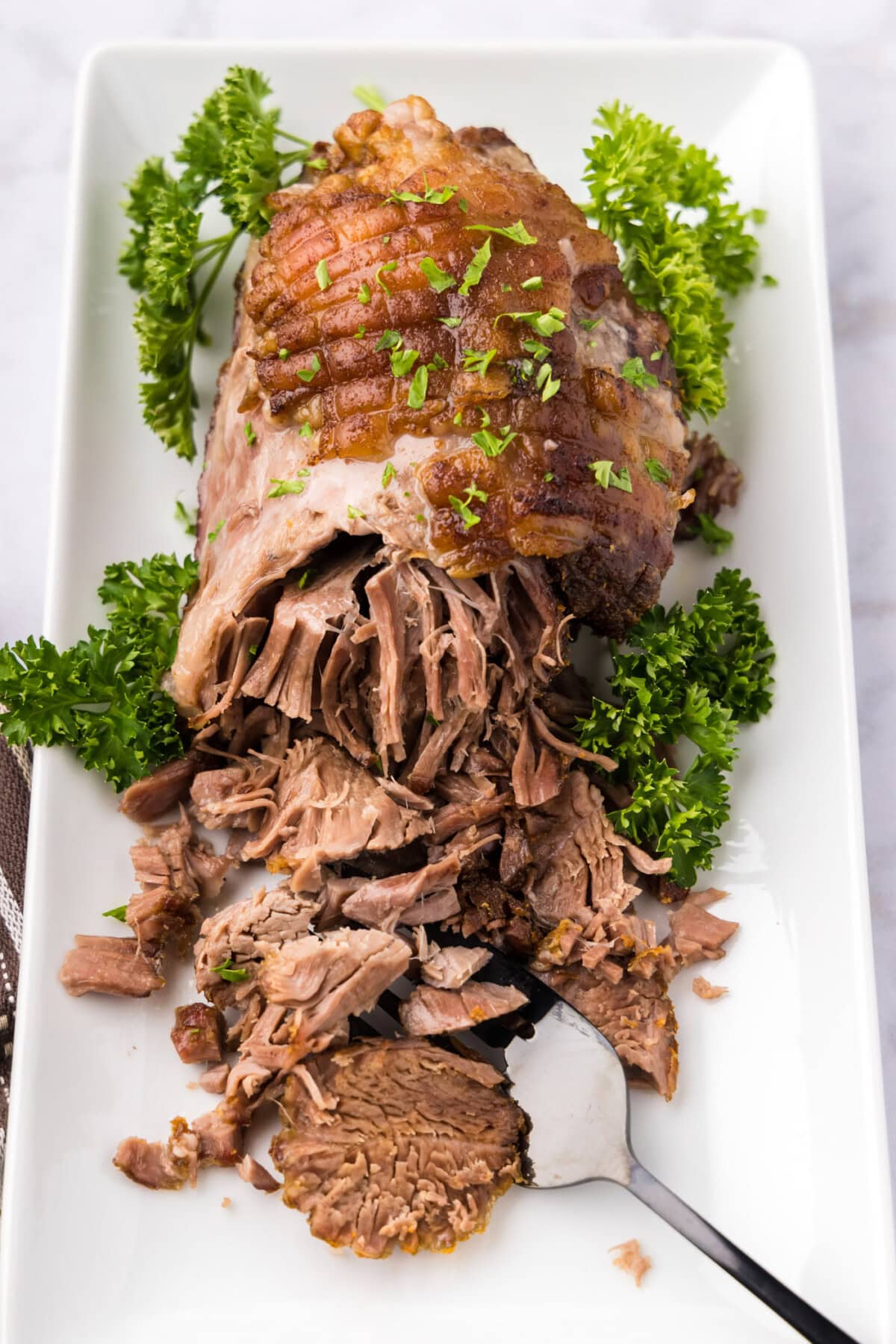 Leg of Lamb on a platter half shredded