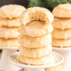 Three stacks of Lemon Drop Cookies with a bite taken off the top cookie