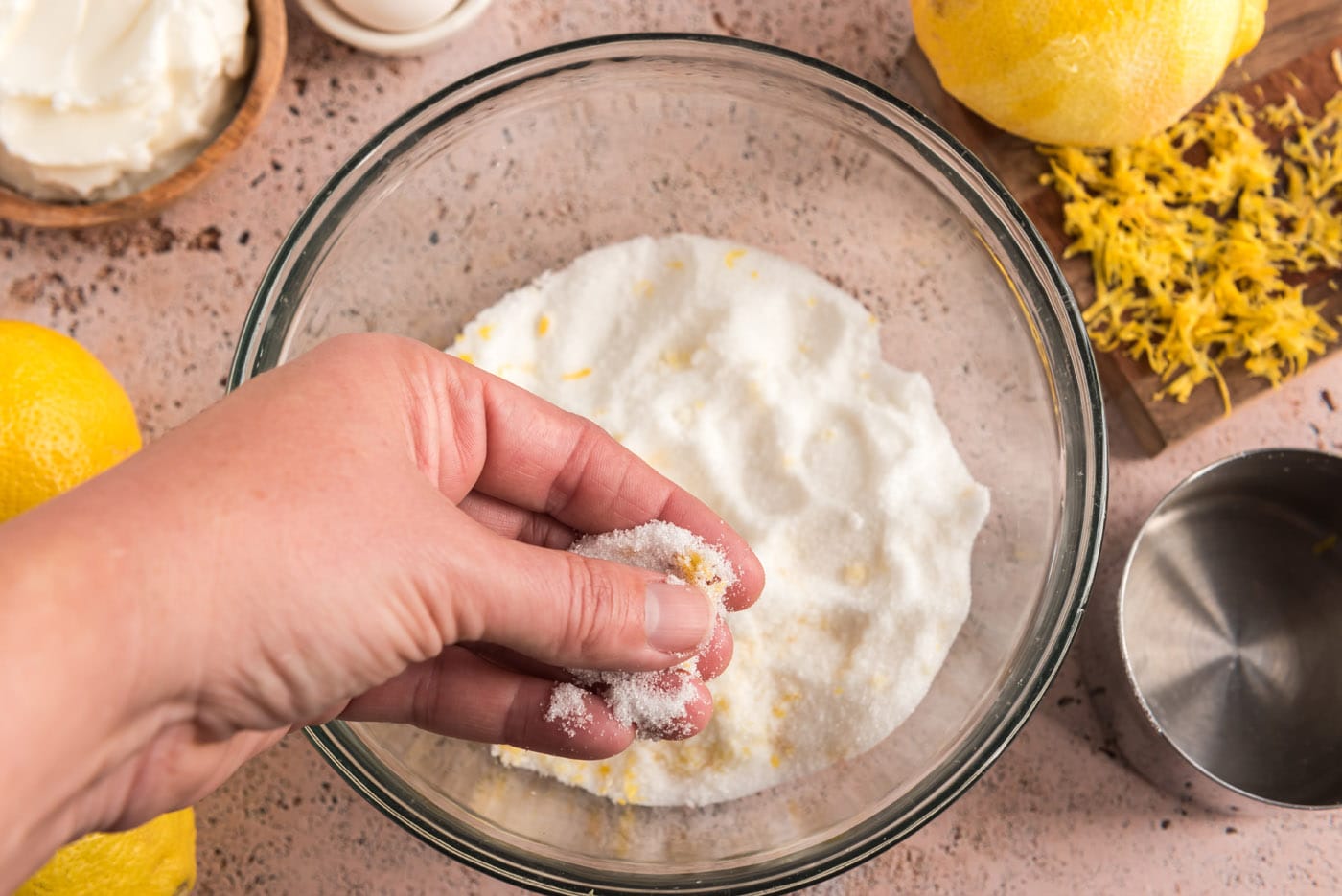 rubbing lemon zest together with sugar