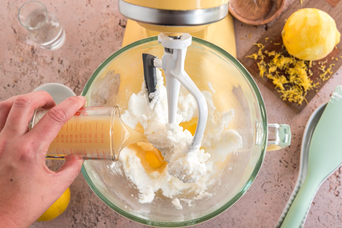 pouring lemon juice into mixture