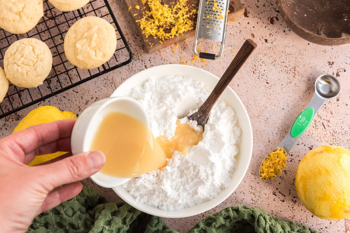 pouring lemon juice into powdered sugar