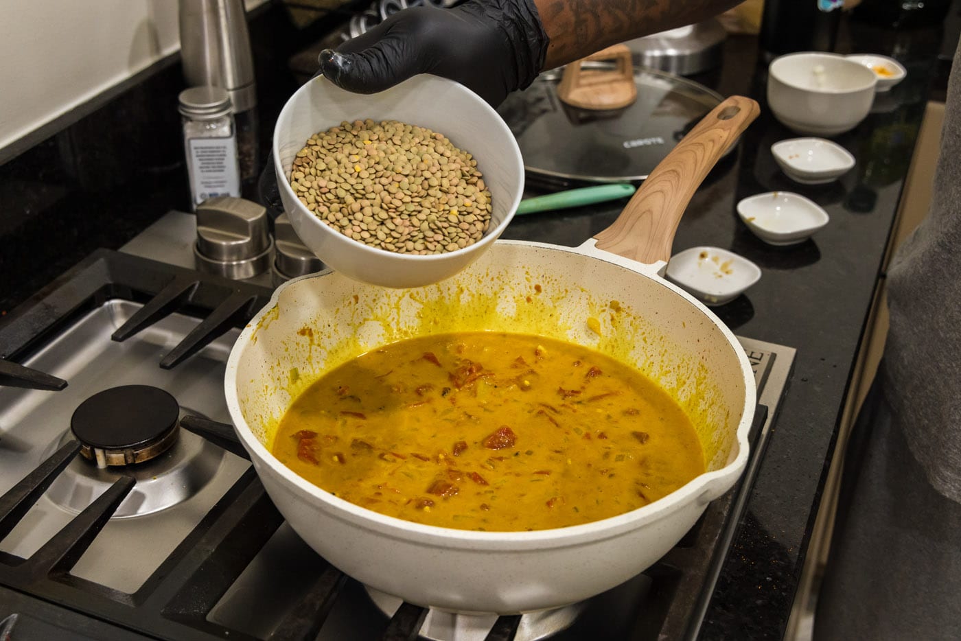 adding brown lentils to curry sauce