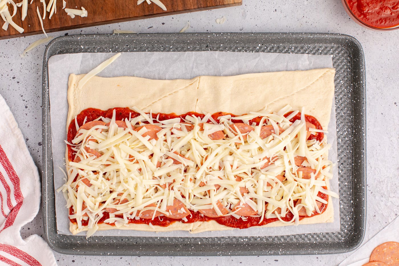 mozzarella cheese on top of pepperoni crescent rolls