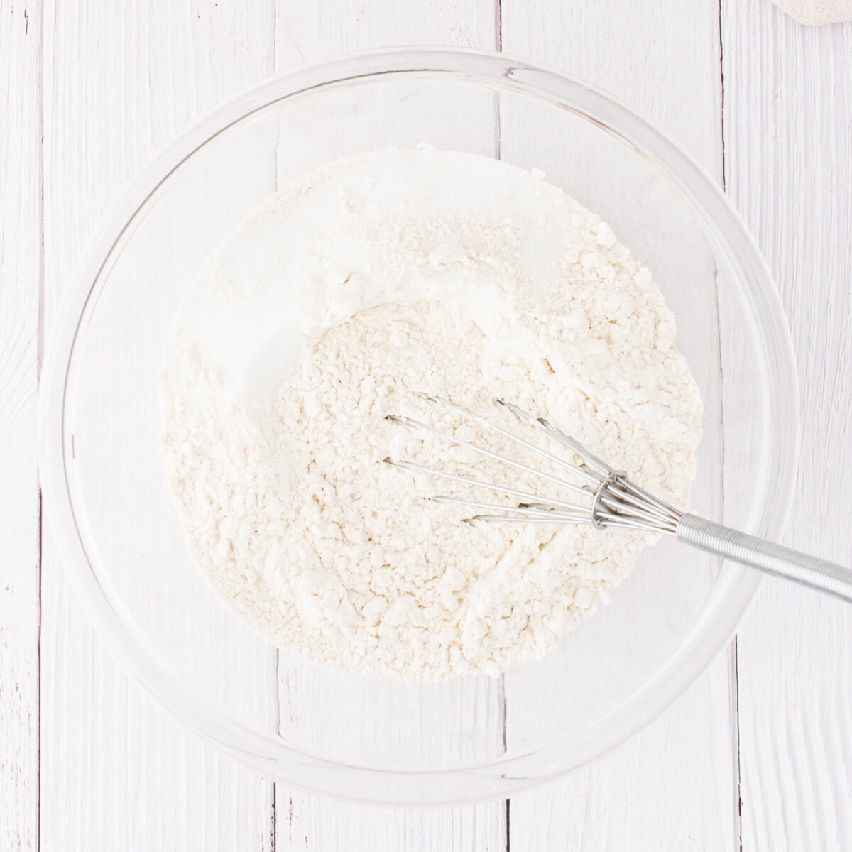 bowl of flour, sugar, and salt with whisk