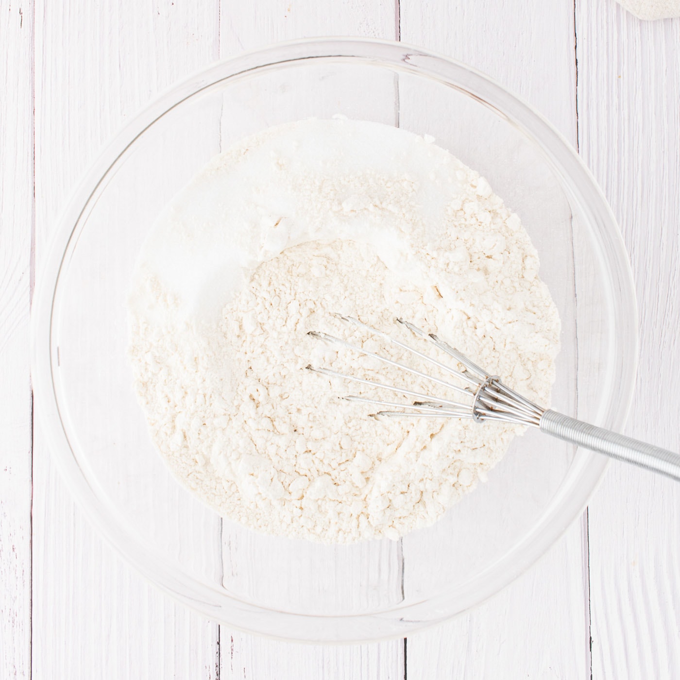 bowl of flour, sugar, and salt with whisk