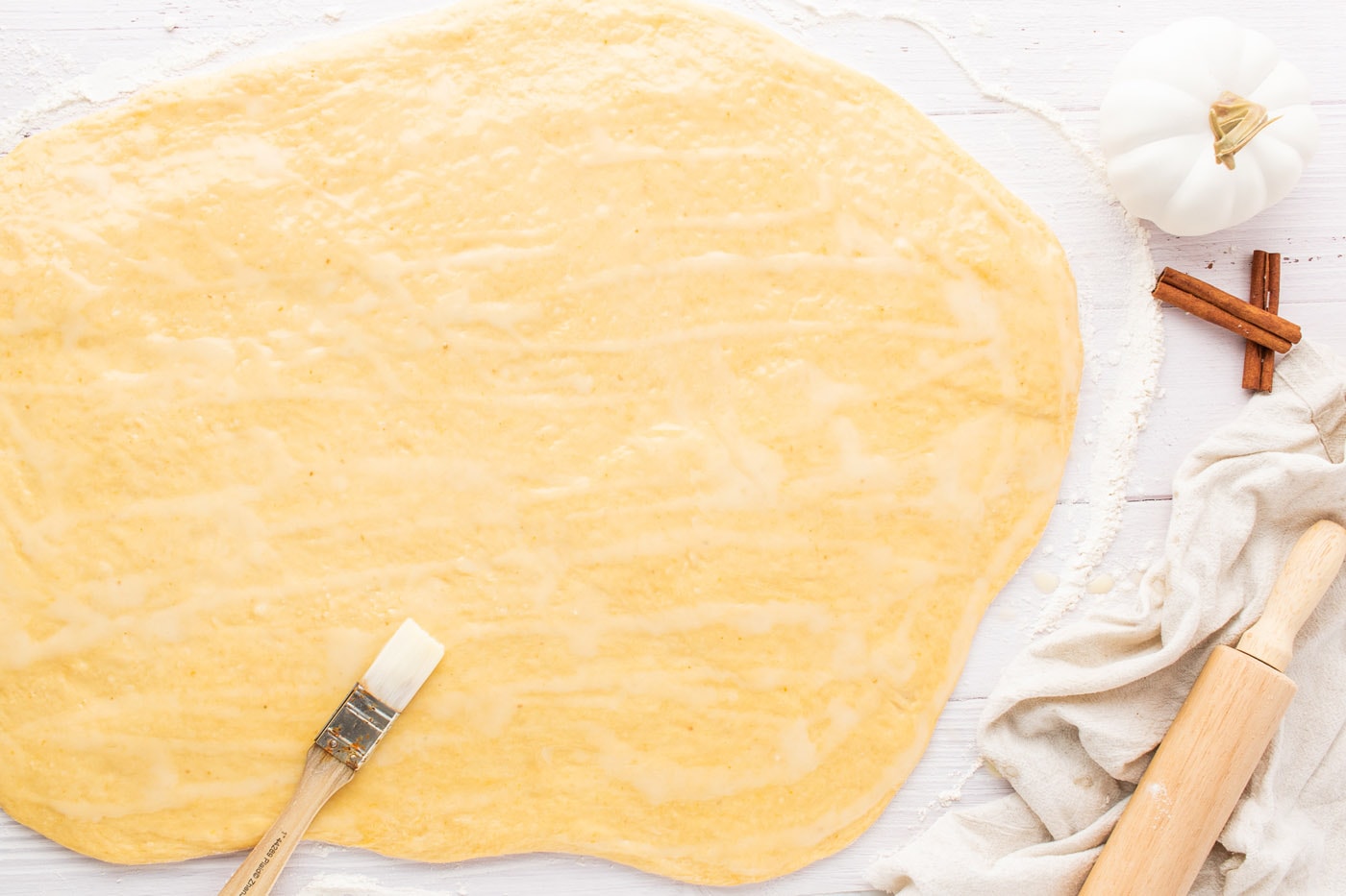spreading butter over dough