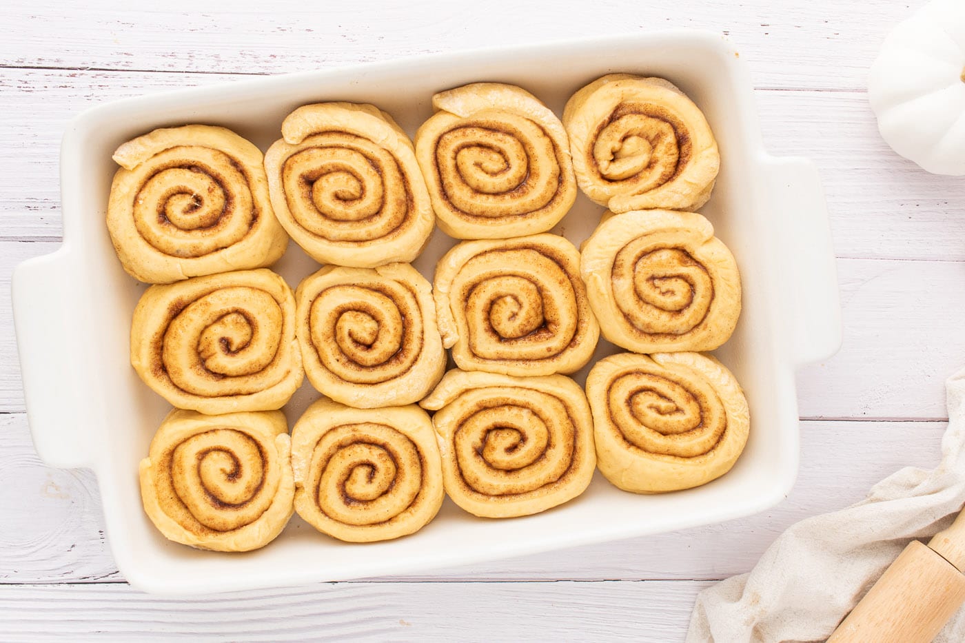 sliced cinnamon rolls in a baking pan