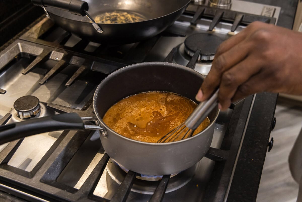 whisking slurry into shrimp and broccoli sauce to thicken