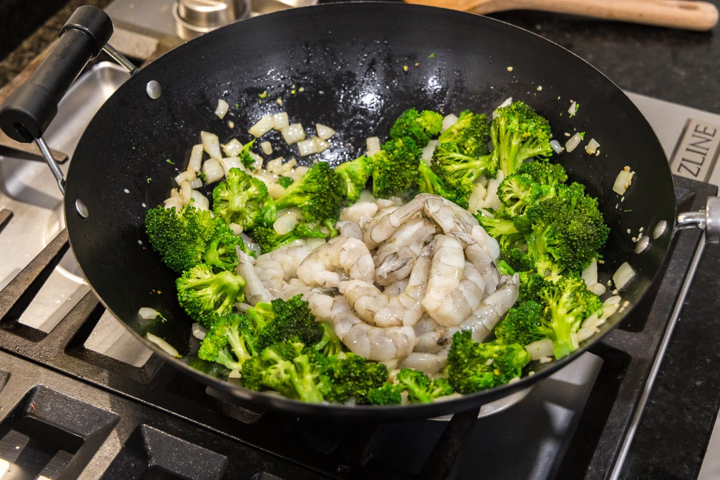 shrimp added to wok with broccoli and onion