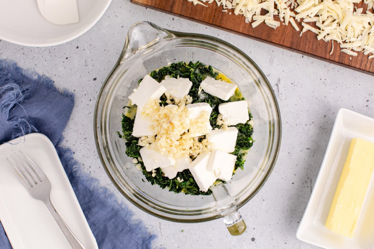 cubed cream cheese, garlic, and pepperjack cheese added to eggs and spinach