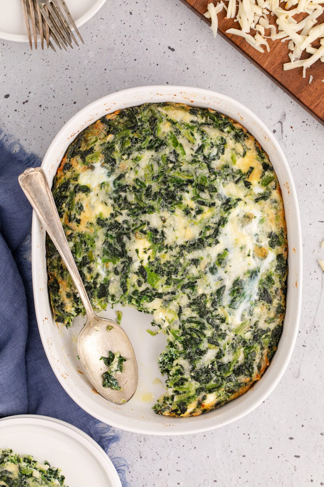 Overhead photo of a spoon resting in a Spinach Souffle