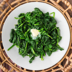 Steamed Spinach on a plate with a pat of butter