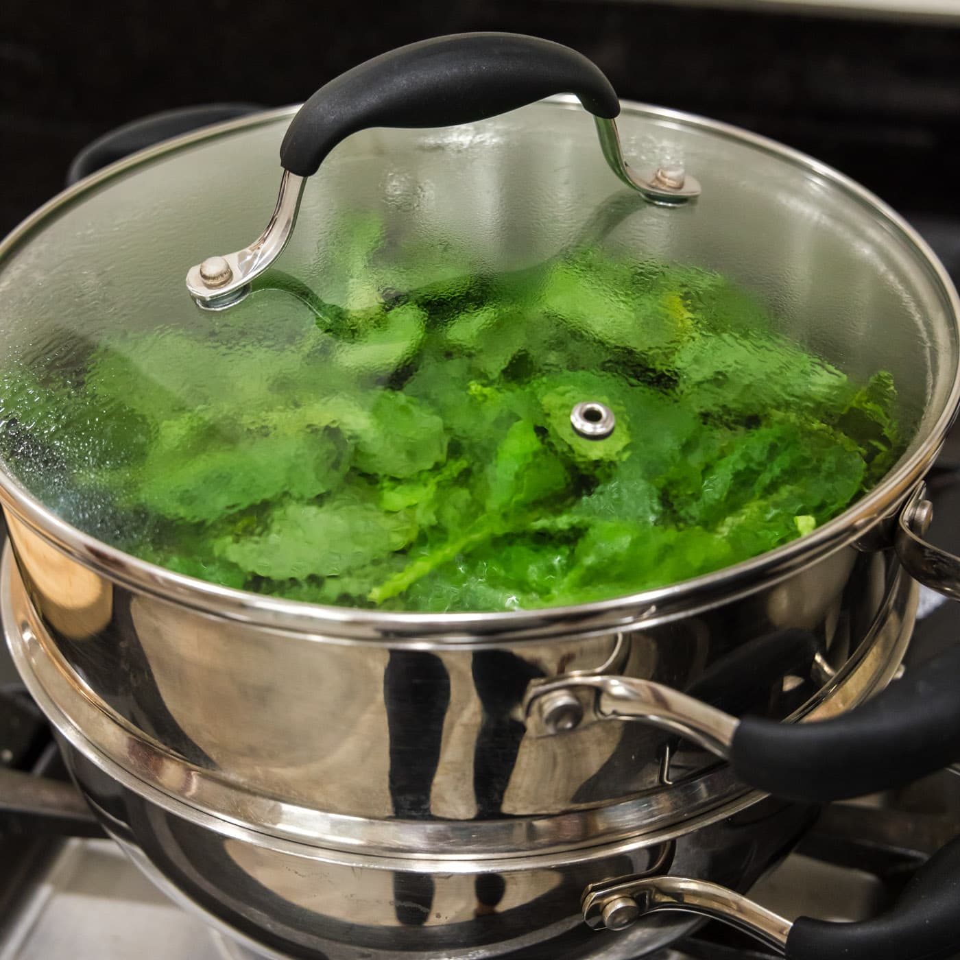 steaming spinach in a steam pot