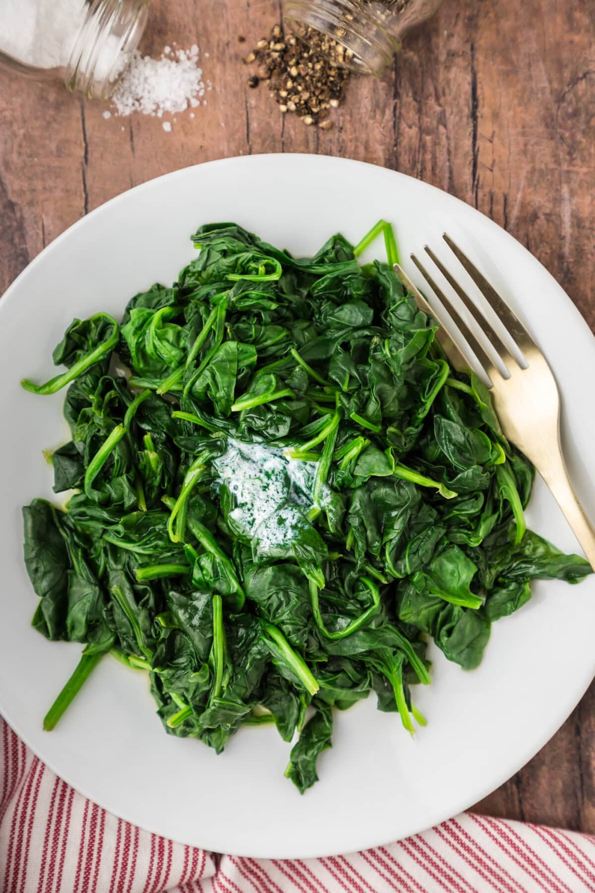 Steamed Spinach on a plate with a fork
