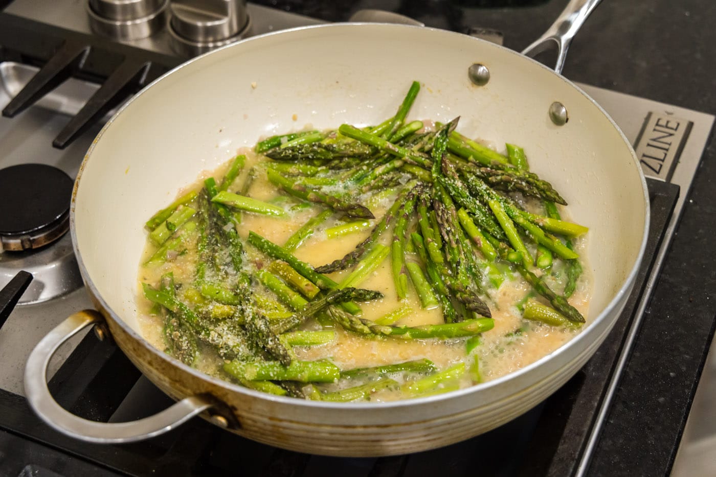 asparagus added to melted butter mixture in skillet