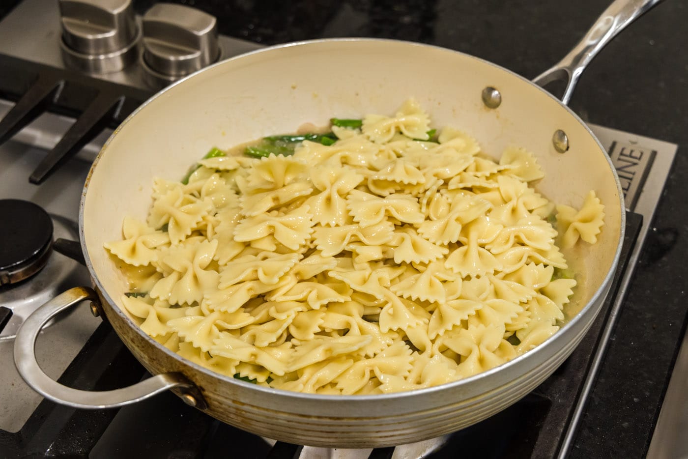 bowtie pasta added to buttered asparagus sauce