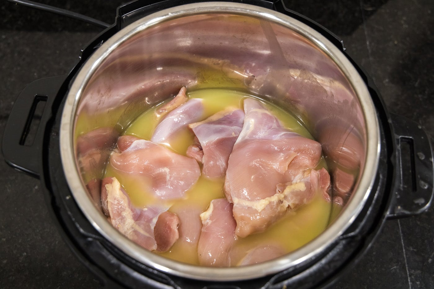 chicken thighs and breasts with chicken stock in an instant pot