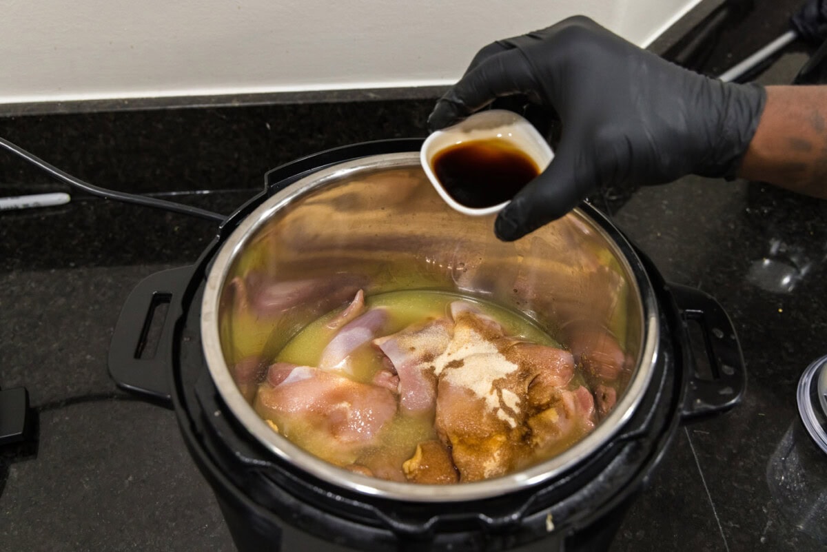 adding Worcestershire sauce to instant pot with chicken