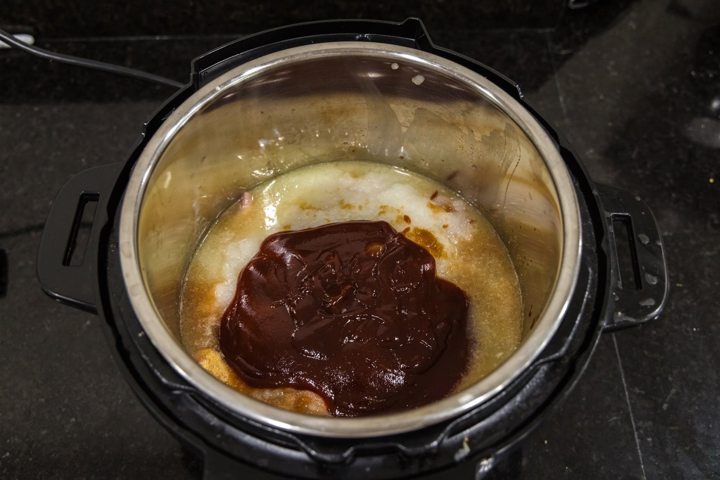 barbecue sauce on top of chicken mixture in instant pot