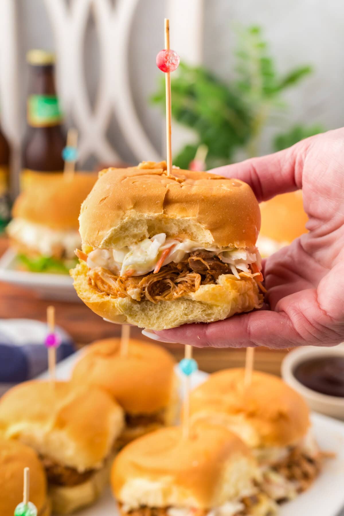 Hand holding up a BBQ Chicken Slider