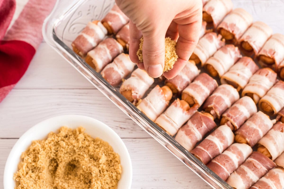 Brown sugar being sprinkled on Bacon Wrapped Little Smokies