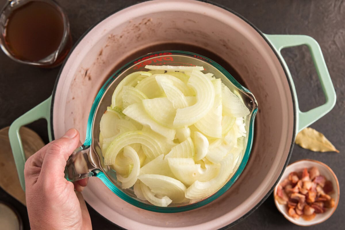sliced onions added to dutch oven