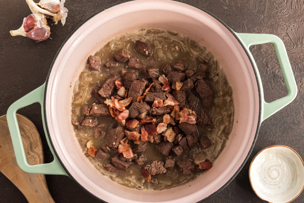 beef and bacon added to pot with onions